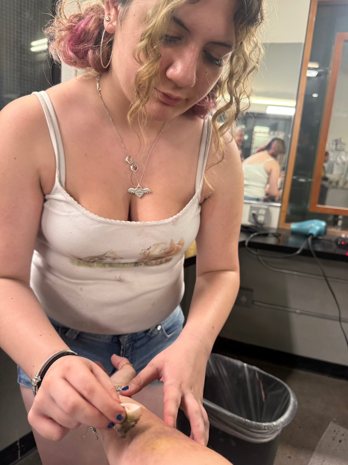 Sophia mid-application, building a forearm wound